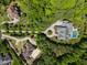 An aerial perspective highlights the property's elegant design, private setting, and proximity to surrounding homes at 219 Colvard Park Dr, Durham, NC 27713