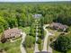 An aerial view showcases the home's prime location nestled within a lush, wooded landscape at 219 Colvard Park Dr, Durham, NC 27713