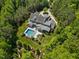 This aerial image highlights the backyard pool, landscaping, and privacy of this stunning property at 219 Colvard Park Dr, Durham, NC 27713