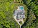 The aerial view captures the backyard pool, showcasing the property's lush landscaping and well-manicured grounds at 219 Colvard Park Dr, Durham, NC 27713