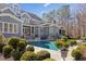 An expansive backyard features a sparkling pool with lush landscaping, perfect for outdoor entertaining at 219 Colvard Park Dr, Durham, NC 27713
