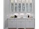 Stylish bar area featuring illuminated glass cabinets, a sink, and a coffee station at 219 Colvard Park Dr, Durham, NC 27713