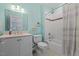 Well-lit bathroom featuring a shower-tub combo with white tile and a stylish vanity at 219 Colvard Park Dr, Durham, NC 27713
