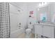 Clean bathroom featuring a tub-shower, marble countertop vanity, and neutral tiling at 219 Colvard Park Dr, Durham, NC 27713