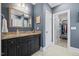Elegant bathroom with granite countertops, dark cabinetry, and a walk-in closet for storage at 219 Colvard Park Dr, Durham, NC 27713