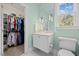 Charming bathroom with a modern sink, a toilet, and an open doorway to an adjacent closet at 219 Colvard Park Dr, Durham, NC 27713