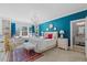 Inviting bedroom with a bright teal accent wall, large windows, and elegant decor at 219 Colvard Park Dr, Durham, NC 27713