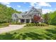 Stunning two-story home boasts manicured lawn, mature landscaping, and timeless architectural details at 219 Colvard Park Dr, Durham, NC 27713