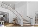Grand two-story foyer with curved staircase, hardwood floors, and elegant architectural details at 219 Colvard Park Dr, Durham, NC 27713