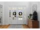 Bright entryway with beautiful double doors, elegant rug, and decorative console table at 219 Colvard Park Dr, Durham, NC 27713