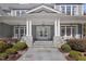Charming front entrance with stone accents, classic columns, and a welcoming double door at 219 Colvard Park Dr, Durham, NC 27713