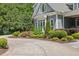 A beautifully landscaped driveway and lush lawn accentuates the exquisite architectural details of this charming residence at 219 Colvard Park Dr, Durham, NC 27713