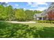 Circular driveway and beautiful landscaping highlight this home's exterior, surrounded by a lush green lawn at 219 Colvard Park Dr, Durham, NC 27713