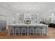 Bright kitchen boasts an oversized island with seating for ten, custom cabinetry and hardwood flooring at 219 Colvard Park Dr, Durham, NC 27713