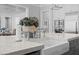Close-up of eat-in kitchen with stainless appliances and sink, stone countertops, and white cabinetry at 219 Colvard Park Dr, Durham, NC 27713