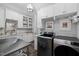Well-organized laundry room with shelving, sink, counter space, and modern washer and dryer at 219 Colvard Park Dr, Durham, NC 27713