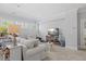 Bright living room featuring modern furniture, neutral colors, and a large window for ample natural light at 219 Colvard Park Dr, Durham, NC 27713