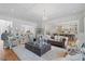Open-concept living room showcasing elegant furnishings and a seamless flow to the kitchen at 219 Colvard Park Dr, Durham, NC 27713