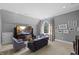 Cozy living room with large TV, comfortable seating, and natural light from a large window at 219 Colvard Park Dr, Durham, NC 27713