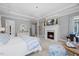 Bright main bedroom with a fireplace, chandelier, and serene decor for a relaxing retreat at 219 Colvard Park Dr, Durham, NC 27713
