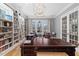 Bright office featuring custom bookshelves with ladder and inviting leather furniture at 219 Colvard Park Dr, Durham, NC 27713