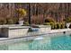 Tranquil pool with a waterfall feature and well-maintained landscaping for a relaxing outdoor space at 219 Colvard Park Dr, Durham, NC 27713