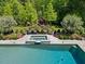 Close up view of the pool and spa shows meticulous flower and shrub landscaping around concrete deck at 219 Colvard Park Dr, Durham, NC 27713