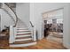 Elegant staircase with wood treads, white risers, and an adjacent study with built-in bookshelves at 219 Colvard Park Dr, Durham, NC 27713