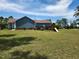 Blue home with large backyard, wooden deck, and a swing set at 22 Woodridge Ln, Cameron, NC 28326