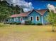 A charming one-story home with blue siding and a well-maintained front lawn at 22 Woodridge Ln, Cameron, NC 28326