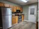 Functional kitchen with stainless steel appliances and a side entrance door at 22 Woodridge Ln, Cameron, NC 28326