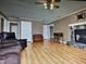 Spacious living room featuring wood floors, a stone fireplace, and a comfortable seating area at 22 Woodridge Ln, Cameron, NC 28326