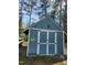 A small blue outbuilding with white doors at 22 Woodridge Ln, Cameron, NC 28326