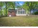 Backyard featuring a well-maintained lawn and a sunroom at 2453 Derby Dr, Raleigh, NC 27610