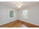 Cozy bedroom showcasing hardwood floors and windows providing natural light at 2453 Derby Dr, Raleigh, NC 27610