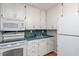 Practical kitchen boasts white cabinets and modern appliances at 2453 Derby Dr, Raleigh, NC 27610