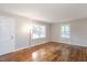Open-plan living room with hardwood floors and neutral paint color at 2453 Derby Dr, Raleigh, NC 27610