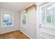 Mud room with wood floors, coat rack, and natural light from the windows at 2453 Derby Dr, Raleigh, NC 27610