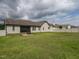 A large, grassy backyard offers privacy with a fence, complemented by the home's exterior and an inviting screened porch at 30 Imperial Dr, Clayton, NC 27527