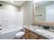 Bright bathroom with shower-tub, tile floors, vanity, granite countertop and framed mirror at 30 Imperial Dr, Clayton, NC 27527