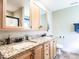 Bathroom featuring dual sinks, granite countertops, and wood cabinetry at 30 Imperial Dr, Clayton, NC 27527