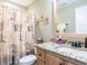 Bathroom boasts a granite countertop and a shower with decorative curtain at 30 Imperial Dr, Clayton, NC 27527