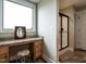 Bathroom with vanity area, granite countertop, framed mirror and tile floor at 30 Imperial Dr, Clayton, NC 27527