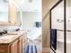Bathroom with dual sinks, granite countertops, and a glass-enclosed shower at 30 Imperial Dr, Clayton, NC 27527