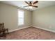 Bright bedroom with ceiling fan, window, and neutral carpet at 30 Imperial Dr, Clayton, NC 27527