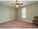 Bright bedroom with ceiling fan, window, and neutral carpet at 30 Imperial Dr, Clayton, NC 27527
