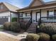 Inviting front porch with brick steps and decorative flower pots leading to the front door at 30 Imperial Dr, Clayton, NC 27527