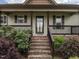 Inviting front porch with brick steps and a black-railed porch that leads to a glass-paned front door at 30 Imperial Dr, Clayton, NC 27527