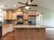 Bright kitchen boasts granite countertops, wooden cabinets, stainless appliances, and a central island at 30 Imperial Dr, Clayton, NC 27527