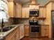 Charming kitchen features stainless steel appliances, granite countertops, and wooden cabinets at 30 Imperial Dr, Clayton, NC 27527